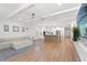 Spacious living room with coffered ceilings, modern furniture, and an open layout connected to the kitchen at 11508 Sage Canyon Dr, Riverview, FL 33578