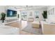 Bright and airy living room with hardwood floors, a large TV, a comfortable sectional sofa, and views of the pool at 11508 Sage Canyon Dr, Riverview, FL 33578