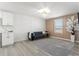 A brightly lit living room with wood-look floors, decorative wall accents, and modern light fixture at 11508 Sage Canyon Dr, Riverview, FL 33578