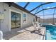 Covered back patio with sliding glass doors and brick pavers with pool and spa views at 11508 Sage Canyon Dr, Riverview, FL 33578