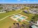 Aerial view of four pickleball courts, palm trees, and sidewalk in a lovely neighborhood setting at 11508 Sage Canyon Dr, Riverview, FL 33578