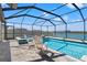 A stunning screened-in pool with attached spa and lake view offers the ultimate relaxation and entertainment space at 11508 Sage Canyon Dr, Riverview, FL 33578