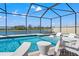 A stunning screened-in pool with in-pool loungers and lake view offers the ultimate relaxation and entertainment space at 11508 Sage Canyon Dr, Riverview, FL 33578