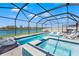 A stunning screened-in pool with spa and lake view offers the ultimate relaxation and entertainment space at 11508 Sage Canyon Dr, Riverview, FL 33578