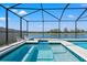 A stunning screened-in pool with attached spa and lake view offers the ultimate relaxation and entertainment space at 11508 Sage Canyon Dr, Riverview, FL 33578