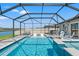 A stunning screened-in pool with spa and lake view offers the ultimate relaxation and entertainment space at 11508 Sage Canyon Dr, Riverview, FL 33578
