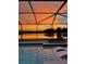 Beautiful sunset reflecting over the backyard pool and lake at 11508 Sage Canyon Dr, Riverview, FL 33578