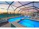 Gorgeous in-ground pool with attached spa, screened-in enclosure and plenty of seating at 11508 Sage Canyon Dr, Riverview, FL 33578