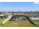 Aerial view of a screened-in pool and hot tub with lounge chairs and outdoor furniture in the backyard at 11508 Sage Canyon Dr, Riverview, FL 33578