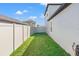 Narrow, grassy side yard of home with privacy fence and gate access to the backyard at 11508 Sage Canyon Dr, Riverview, FL 33578