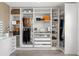 Custom closet with shelving, drawers, a makeup mirror, and wood-look floors at 11508 Sage Canyon Dr, Riverview, FL 33578