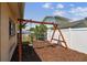 Well-kept backyard play area featuring a swing set and mulch for safety at 11746 93Rd Ave, Seminole, FL 33772