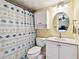 Bathroom featuring a vanity with mirror, toilet, and shower with themed curtain at 11746 93Rd Ave, Seminole, FL 33772