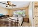 Well-lit bedroom with wood furnishings, ceiling fan, and bright natural light at 11746 93Rd Ave, Seminole, FL 33772