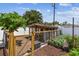 Wooden chicken coop surrounded by a garden area with raised beds and lush greenery at 11746 93Rd Ave, Seminole, FL 33772