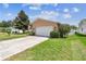 Well-maintained single-story home with a paved driveway and lush green lawn at 11746 93Rd Ave, Seminole, FL 33772