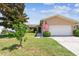 Charming single-story home with a manicured lawn and an attached two-car garage at 11746 93Rd Ave, Seminole, FL 33772