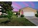 Charming single-story home with a manicured lawn and an attached two-car garage at 11746 93Rd Ave, Seminole, FL 33772