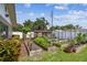 Backyard garden area with raised beds, a chicken coop, and surrounding lush vegetation at 11746 93Rd Ave, Seminole, FL 33772