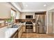 Well-lit kitchen boasts stainless steel appliances and ample counter space at 11746 93Rd Ave, Seminole, FL 33772