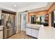 View of stainless steel refrigerator and white countertops at 11746 93Rd Ave, Seminole, FL 33772