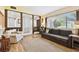 Cozy living room with hardwood floors, large windows, and a comfortable seating area at 11746 93Rd Ave, Seminole, FL 33772