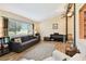 Bright living room with hardwood floors, a ceiling fan, and large windows for natural light at 11746 93Rd Ave, Seminole, FL 33772