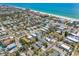 Breathtaking aerial view of homes nestled near a stunning coastline with crystal-clear turquoise waters at 123 14Th Ave, Indian Rocks Beach, FL 33785