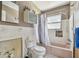 Bathroom featuring a tub with shower, tile, vanity, and natural light at 123 14Th Ave, Indian Rocks Beach, FL 33785