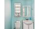 Powder room with a sink, mirror, window, and toilet at 123 14Th Ave, Indian Rocks Beach, FL 33785