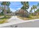Exterior front of home with palm trees and tropical foliage creating a serene setting at 123 14Th Ave, Indian Rocks Beach, FL 33785
