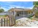 A well-maintained home boasting a screened porch, gravel landscaping and a neatly fenced yard at 123 14Th Ave, Indian Rocks Beach, FL 33785