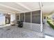 Enjoy outdoor living on this home's spacious screened porch with a comfortable patio area at 123 14Th Ave, Indian Rocks Beach, FL 33785