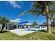 Expansive backyard featuring a patio, pool, and lush landscaping, ideal for outdoor living at 12300 4Th E St, Treasure Island, FL 33706