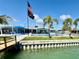 Backyard features a pool, lounge seating, a patio, and a canal view with a dock at 12300 4Th E St, Treasure Island, FL 33706