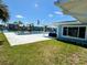 Backyard view of the pool, bar, and patio with water view, highlighting outdoor living at 12300 4Th E St, Treasure Island, FL 33706