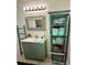 Charming bathroom features rustic vanity with a decorative mirror and vintage-style storage cabinet at 12300 4Th E St, Treasure Island, FL 33706