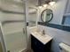 Modern bathroom with step-in shower, granite counters, and decorative mirror at 12300 4Th E St, Treasure Island, FL 33706