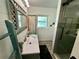 Cozy bathroom features modern sink vanity, wooden accents, and glass enclosed shower stall at 12300 4Th E St, Treasure Island, FL 33706