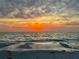 Picturesque beach scene with a stunning sunset over the ocean, perfect for evening strolls and relaxation at 12300 4Th E St, Treasure Island, FL 33706