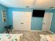 Bedroom featuring a mounted TV, closet, and stylish beach decor at 12300 4Th E St, Treasure Island, FL 33706