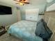 Relaxing bedroom with ceiling fan, large bed, and mounted TV on the wall at 12300 4Th E St, Treasure Island, FL 33706