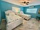Bedroom with two beds, ceiling fan, AC unit and beach-themed decor at 12300 4Th E St, Treasure Island, FL 33706