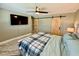 Comfortable bedroom features a ceiling fan, TV, wood floors and sliding barn doors at 12300 4Th E St, Treasure Island, FL 33706
