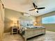 Bedroom featuring a ceiling fan, AC unit, and a sliding barn door at 12300 4Th E St, Treasure Island, FL 33706