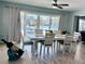 Water view dining room features coastal decor, neutral colors and sliding glass doors to the patio at 12300 4Th E St, Treasure Island, FL 33706