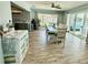 Bright dining room with a sliding glass door to the lanai, bar, and coastal decor at 12300 4Th E St, Treasure Island, FL 33706