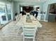 The open floorplan dining room looks out to a lanai, living room, and seating area at 12300 4Th E St, Treasure Island, FL 33706