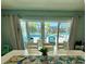 Dining room boasts sliding doors with views of a canal and a covered patio at 12300 4Th E St, Treasure Island, FL 33706