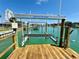 Boat lift is located at the end of the wooden boat dock on the canal at 12300 4Th E St, Treasure Island, FL 33706